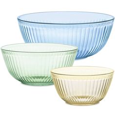 three different colored glass bowls sitting next to each other