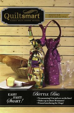 an advertisement for quiltsmart featuring two wine bottles and a basket on a table