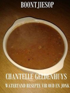 a bowl of soup sitting on top of a wooden table