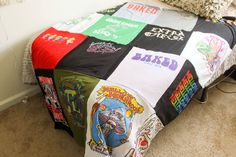 a bed covered in lots of different types of t - shirts on it's cover