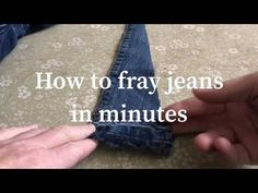 someone is trying to fix an old pair of jeans