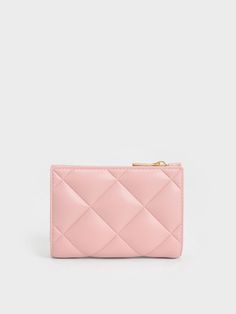 a pink wallet with a gold zipper