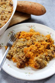 a white plate topped with food next to a casserole dish filled with stuffing