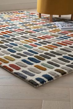 a multicolored area rug on the floor