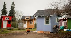 a bicycle parked in front of a small blue house