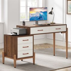 a computer desk with drawers and a monitor