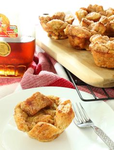 a plate with some muffins on it next to a jar of honey