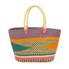 a multicolored straw bag with handles on the front and side, sitting against a white background