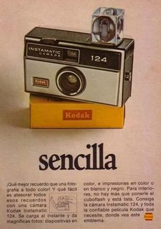 an old camera sitting on top of a yellow box with the words'kodak'written below it