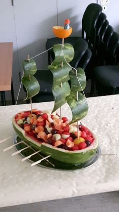 a boat made out of fruit on a table