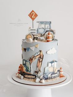 there is a cake with construction vehicles on it