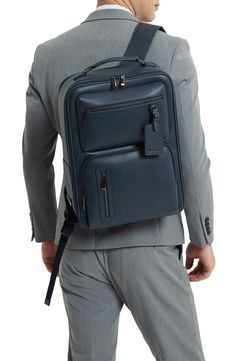 This faux-leather backpack features a slim, structured silhouette and a water-resistant finish that keeps your items safe. 11.4"W x 15.9"H x 5.5"D Water-resistant Synthetic Imported Elegant Leather Backpack With Zipper, Modern Faux Leather Backpack, Elegant Leather Backpack With Zipper Closure, Modern Leather Satchel Backpack For Work, Modern Rectangular Leather Backpack For Work, Modern Faux Leather Backpack For Travel, Classic Rectangular Backpack For Work, Business Backpack In Soft Leather, Luxury Leather Backpack With Luggage Sleeve For On-the-go