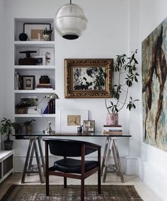 a room with a desk, chair and bookshelf