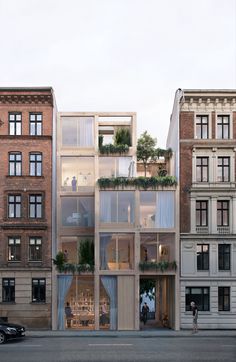 an apartment building with several balconies and plants on the top floor is shown