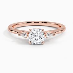 a rose gold engagement ring with an oval center stone and pave set diamonds around the band