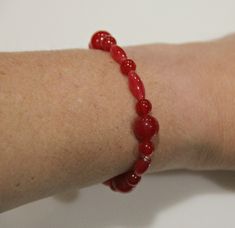 "SBR30- Dyed Red Quartz Bead Stretch Bracelet- Handmade One of a Kind Artisan Bracelet Made in the USA. Beads measure 10mm/ 6 mm and 13 x 5 mm and the bracelet is approx. 7\". Will stretch to fit most wrists. According to metaphysical practitioners, red quartz encourages positive action and produces an abundance of physical energy and vitality; because it also has many of the properties of clear quartz, it is considered a dynamic healing tool." Handmade Adjustable Red Pearl Bracelet, Handmade Red Adjustable Pearl Bracelet, Handmade Adjustable Red Coral Beaded Bracelets, Handmade Red Pearl Bracelet With Round Beads, Adjustable Red Gemstone Beads Stretch Bracelet, Red Adjustable Stretch Bracelet With Polished Beads, Red Spiritual Stretch Bracelet, Red Quartz, Resize Ring