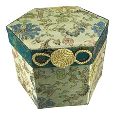 an ornately decorated box is shown with rope on it's lid and handles