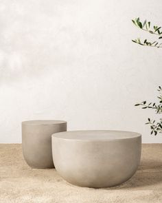 two concrete bowls sitting on top of a table