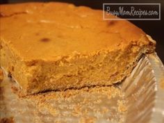 a piece of pumpkin pie sitting on top of a glass cake plate next to a fork