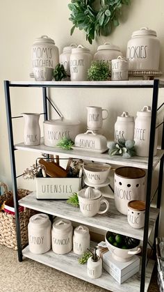 the shelves are filled with white dishes and mugs, pots and plants on them