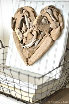 a heart made out of mushrooms sitting on top of a book next to a basket