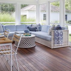 a sun room with blue and white furniture