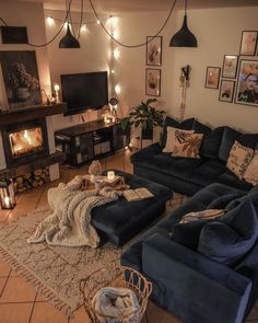 a living room with blue couches and pictures on the wall