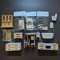 wooden furniture and accessories are laid out on the table for making dollhouse kitchen sets