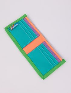 This rad wallet is the perfect place to keep all of your money related objects! Features 6 front-facing credit card slots with 2 extra hidden slots, a main cash pocket, color block detailing, and nylon binding. Shop all WalletsShop all Tippy Talk Measures 9" wide x 4" tall unfolded, 4.5" wide folded.Water resistant 100% Coated Nylon Made in Los Angeles, California Everyday Multicolor Bifold Wallet, Green Rfid Blocking Trifold Wallet For Travel, Multicolor Rfid-blocking Card Holder For Travel, Green Rfid Blocking Trifold Wallet, Multicolor Rfid Blocking Card Holder For Travel, Green Trifold Wallet With Rfid Blocking, Green Rectangular Trifold Wallet With Rfid Blocking, Green Trifold Wallet With Rfid Blocking For Daily Use, Functional Foldable Rectangular Wallet