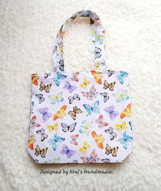 "Small Batch Handmade Kids Cotton Mini Totebag with a lovely Butterfly print fabric on the outside and a blend Orang me Polka dot fabric on the inside.  And butterfly cotton straps. Measures approximately 9.5\" wide x 8.5\" tall with 14\" straps. The bags are for older toddlers  ages 4 and up. Preschool age. Please supervise child with strapbag at all times." Everyday Butterfly Print Tote Bag, White Fabric Bag For Gifts, Chesapeake Va, Preschool Age, Toddler Age, Dot Fabric, Polka Dot Fabric, Handmade Kids, Butterfly Print