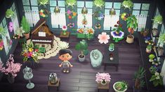 a room filled with lots of plants and flowers on top of a hard wood floor