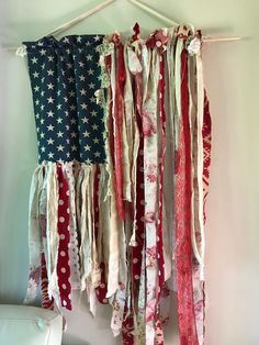 an american flag hanging on a wall with some ribbons attached to the back of it