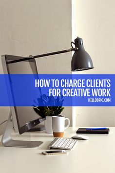 a desk with a computer monitor, keyboard and mouse on it that says how to charge client's for creative work