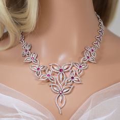 New to our Millennium collection, These beautiful romantic DIAMOND Pink FLORAL VINE LEAVES bridal earrings and necklace set are made of very fine quality of Swarovski crystals/ Cz diamonds and plated with platinum for your special day! Even we have hard time taking pictures because of their shine 😄 so we want to shine our brides on their special days. Simulated diamonds are also known as diamond simulants and include things like cubic zirconia (CZ), moissanite, and YAG. They can also include so Wedding Ruby Necklace With Sparkling Stones, Ruby Necklace With Sparkling Stones For Wedding, Ruby Necklaces With Sparkling Stones For Wedding, Elegant Ruby Bridal Earrings For Wedding, Red Diamond Bridal Earrings For Wedding, Elegant White Ruby Jewelry Sets, Elegant Ruby Bridal Earrings For Anniversary, Ruby Fine Jewelry Sets For Wedding, Elegant Pink Ruby Jewelry Sets