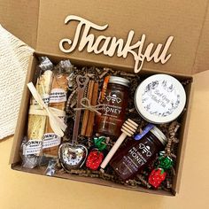 a box filled with jams, cookies and other items that says thank you on it