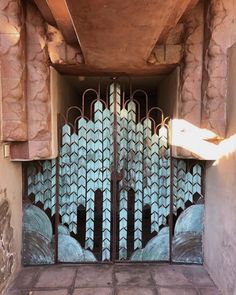 an iron gate with blue and white designs on it