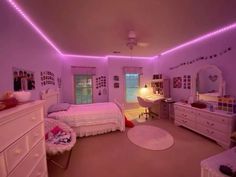 a bedroom with purple lighting and white furniture