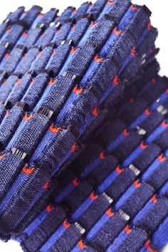 a close up of a blue and red tie on a white surface