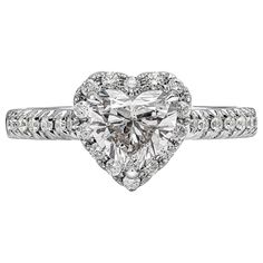 a heart shaped diamond ring with diamonds around it