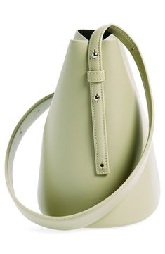 A clean-lined minimalist design defines this just-the-essentials bucket bag crafted of smooth calfskin leather. The adjustable strap is wider in the middle for a comfortable carry, either in hand or over the shoulder. Magnetic-snap closure Adjustable shoulder strap Structured silhouette with flat base for stability Leather Made in Italy Designer Handbags Black Owned/Founded Chic Bucket Bag With Smooth Grain For Work, Smooth Grain Bucket Bag For Work, Modern Bucket Bag With Leather Lining For Work, Modern Bucket Bag With Snap Closure For Daily Use, Modern Bucket Bag With Snap Closure, Structured Leather Bucket Bag For Everyday, Chic Smooth Grain Bucket Shoulder Bag, Chic Top Handle Bucket Bag, Modern Green Bucket Bag