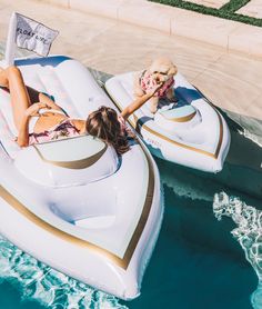 a woman laying on top of an inflatable boat next to a swimming pool