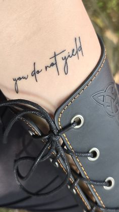 a woman's foot with a tattoo saying you do not afraid