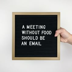 a hand holding up a sign that says, a meeting without food should be an email