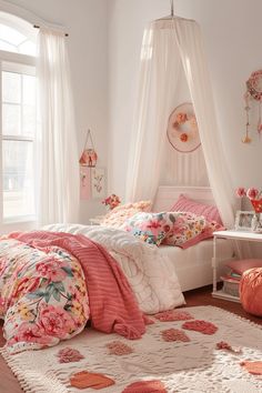 a bedroom with white walls and pink flowers on the bedspread, rugs and pillows