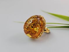 Amber ring. Brown cognac Amber. Certificated Sterling silver 925 with stamps - hallmarks. Big nice stunning ring. Adjustable size. Very big and stunning amber gemstone ring.  weight  16,82 gr GOLD plated ring.  Stone size - 3 x 2,5  cm This item was made of natural Baltic Amber. All the amber used in my jewelry is collected in my home country Lithuania.  I sell only genuine,  real, not pressed, authentic, natural Baltic Amber. Item may have natural imperfections. Amber Gemstone, Multicolor Earrings, Amber Earrings, Amber Ring, Natural Amber, Amber Necklace, Amber Beads, Ring Stone, Amber Jewelry