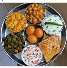 a silver plate topped with different types of food