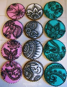 twelve handmade buttons with black and pink paisley designs on them, all in different colors