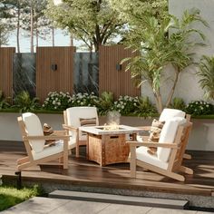 a wooden deck with chairs and a table on top of it next to a planter