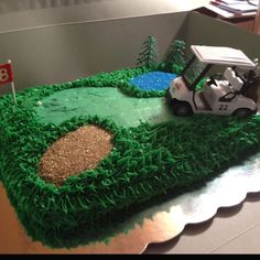 a golf themed birthday cake with green grass and white car on the course in the background