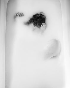 a man in a bathtub with his head above the water